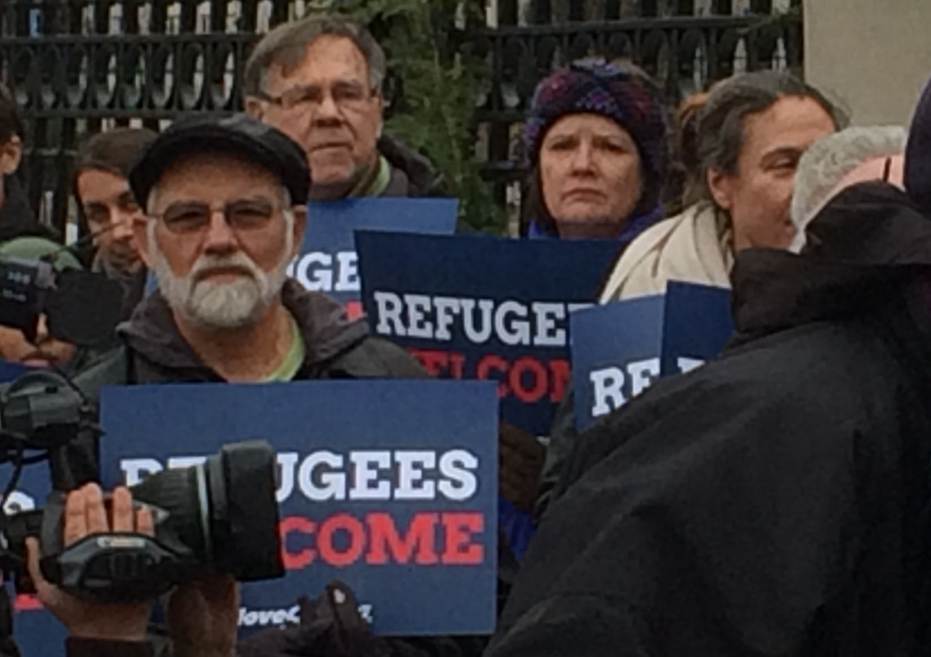 Protest signs say refugees are welcome