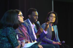 panelist Hamse Warfa speaking with Martha and Erika