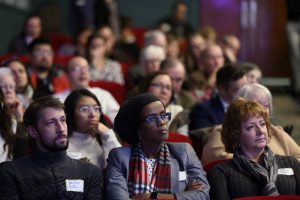 people in theater listening to speakers