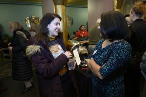 ILCM Executive Director Veena Iyer speaking with an attendee of the event