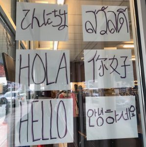 a store window with "hello" written in six different languages