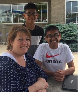 Social ministry worker Lisa Kremer with Bryan and Eugenio, two young people from the “Dream Catchers” program in Southern Minnesota, where immigrant parents have found jobs in agriculture and food processing. 