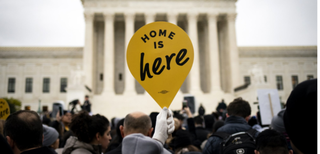 "Home is here" sign held in front of supreme court building